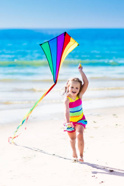 istock Child flying kite on tropical beach 671750808