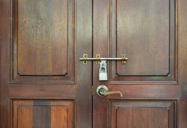 istock Locked wooden vintage door with padlock and handle 671751122