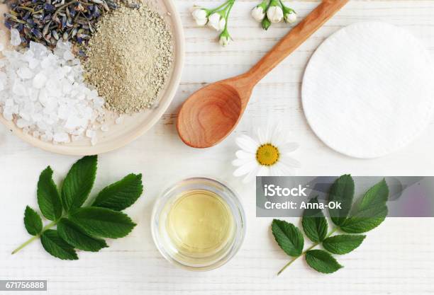 Cosmetic Oil Clay Sea Salt Herbs Plant Leaves Facial Treatment Preparation Background Stock Photo - Download Image Now