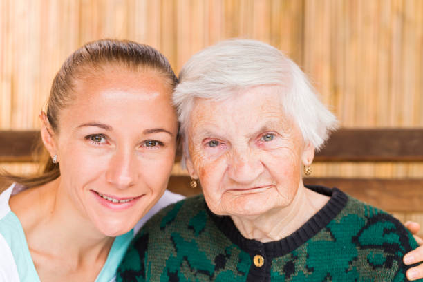 istock Elderly woman with caregiver 671764346