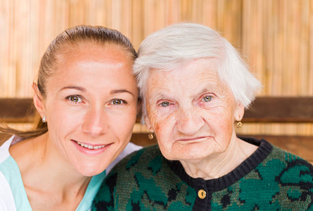 istock Elderly woman with caregiver 671764512