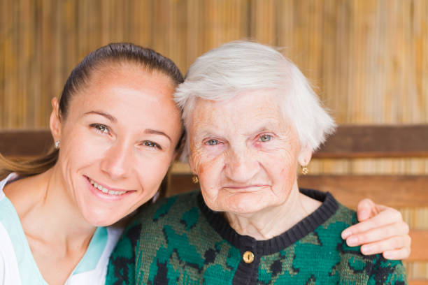istock Elderly woman with caregiver 671767070