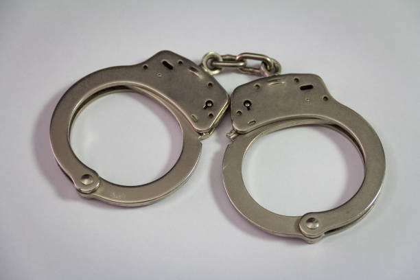 istock Police handcuffs isolated on white background 671767138
