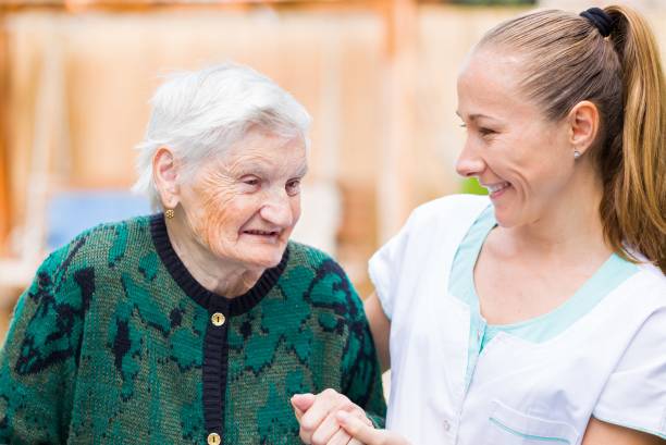 istock Elderly woman with caregiver 671767154