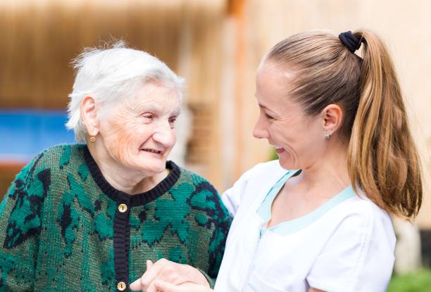 istock Elderly woman with caregiver 671767170