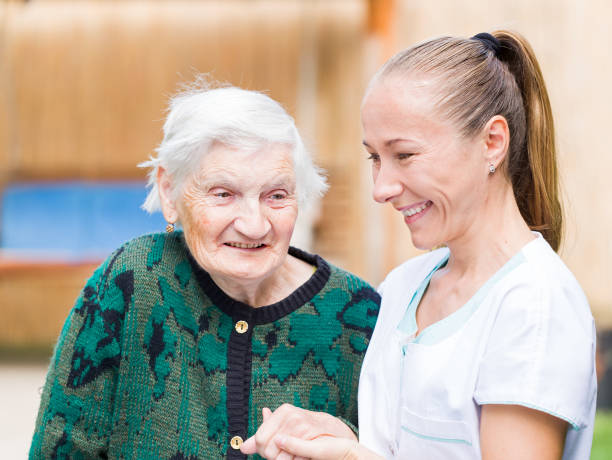 istock Elderly woman with caregiver 671767300