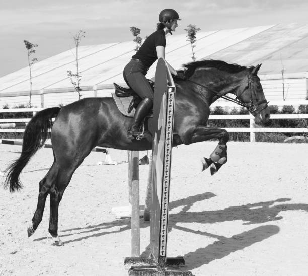 istock Woman jumping on a horse in Jumper Ring 671770032
