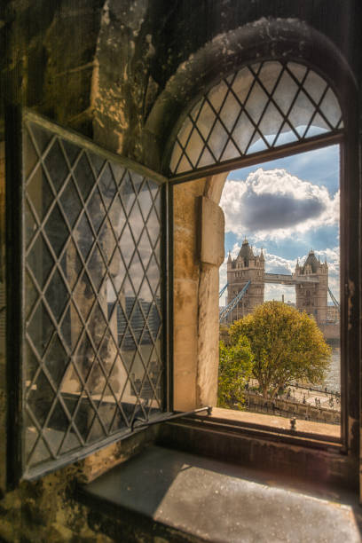 Portrait of Tower Bridge from an old Window at Tower of London stock photo