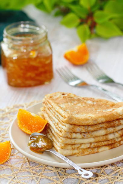 istock Pancakes with orange jam and fruit 671776042