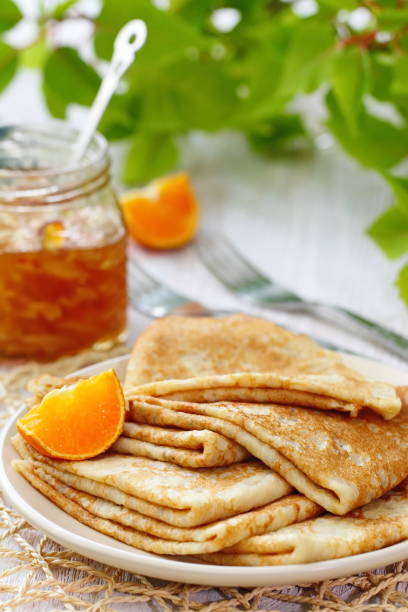 istock Pancakes with orange jam and fruit 671776050