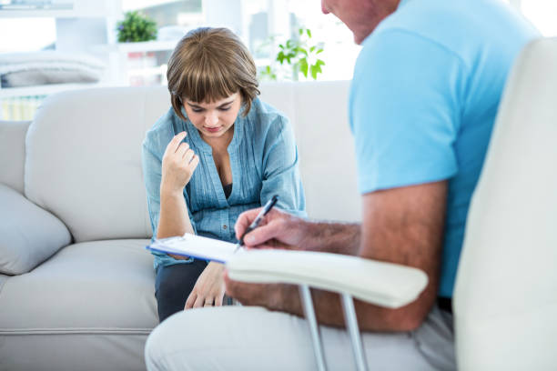 istock Doctor writing on notepad while consulting female patient 671776134