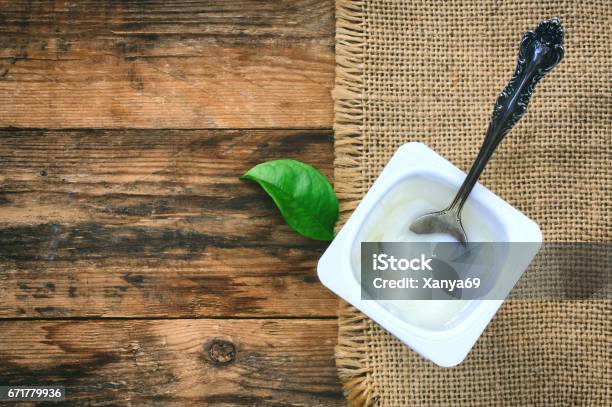 Yogurt In A Plastic White Container Vintage Spoon Stock Photo - Download Image Now - Jar, Yogurt, Simplicity