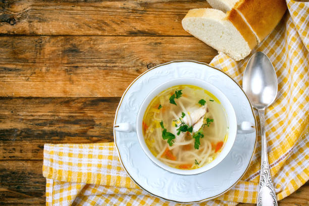 istock Home chicken soup with noodles, vintage spoon, tablecloth 671783772