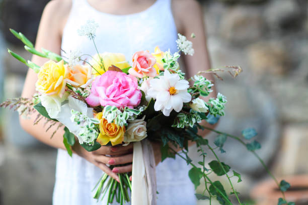istock Young bride in white wedding dress holding beautiful bouquet 671789908
