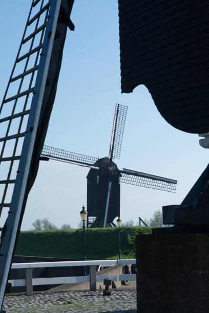 istock Small river harbor, drawbrige and windmill in Heusden - old village in Brabant 671790080