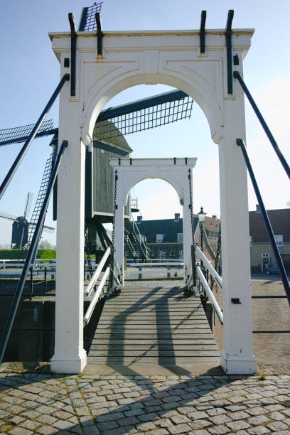 istock Small river harbor, drawbrige and windmill in Heusden - old village in Brabant 671790092