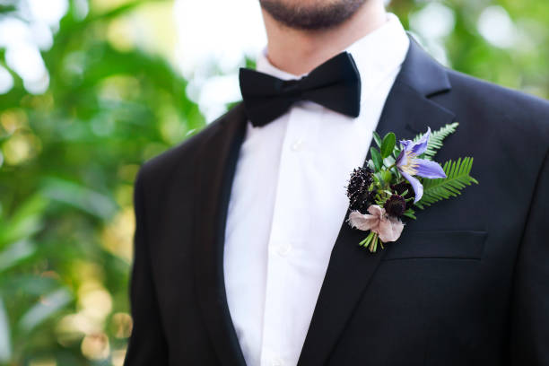 Gentle groom boutonniere Gentle groom boutonniere with roses, chrysanthemum and beads buttonhole flower stock pictures, royalty-free photos & images