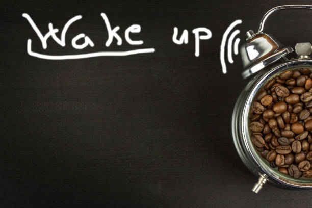 istock Wake up. Retro alarm clock with coffee beans. 671799110