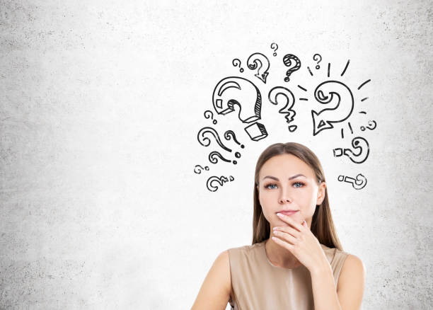 istock Woman in beige and question marks, concrete 671799374