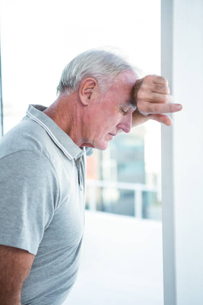 istock Depressed mature man leaning on wall 671799796