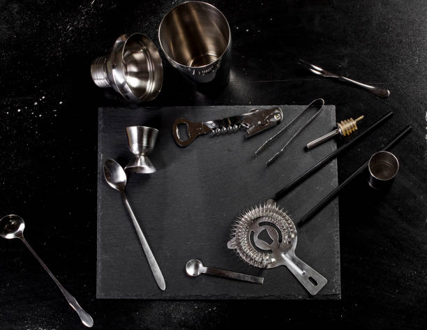Set of bar accessories for making a cocktails Set of bar accessories for making a cocktails arranged on a stone board and black background with copy space pallet jack handle stock pictures, royalty-free photos & images