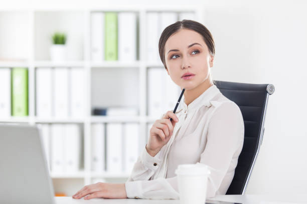 istock Businesswoman working on laptop with pen 671803002