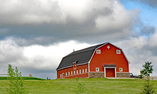 istock Red barn at different seasons of the year- summer 671803262