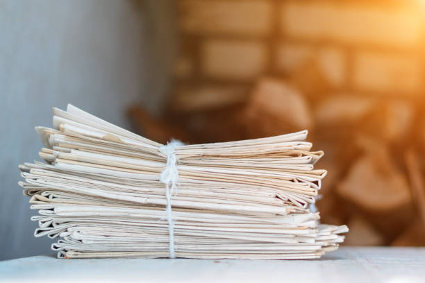 istock Greater pack of newspapers on a table with a rope 671803412