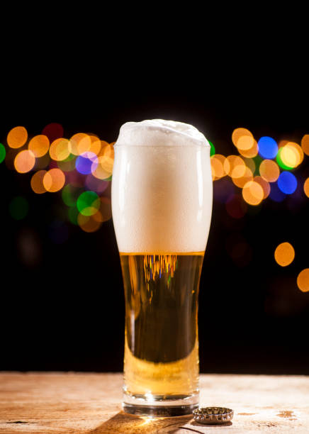 istock Glass of beer on bar lights background 671803638
