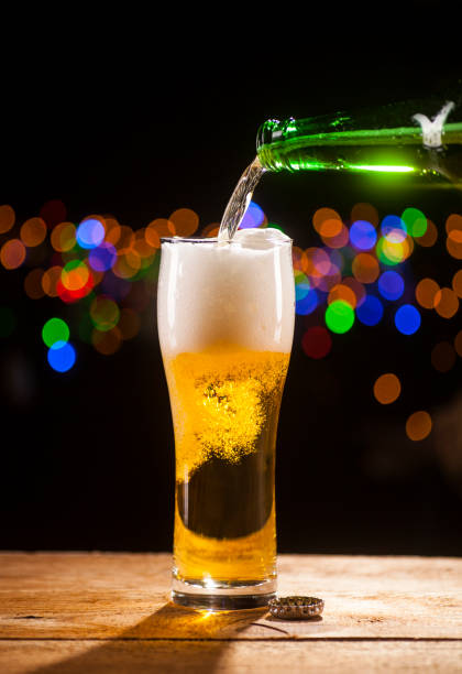 istock Beer is pouring into glass on bar lights background 671803648