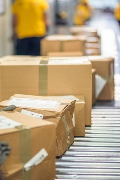 istock Cardboard box packages moving on a conveyor belt 671806082
