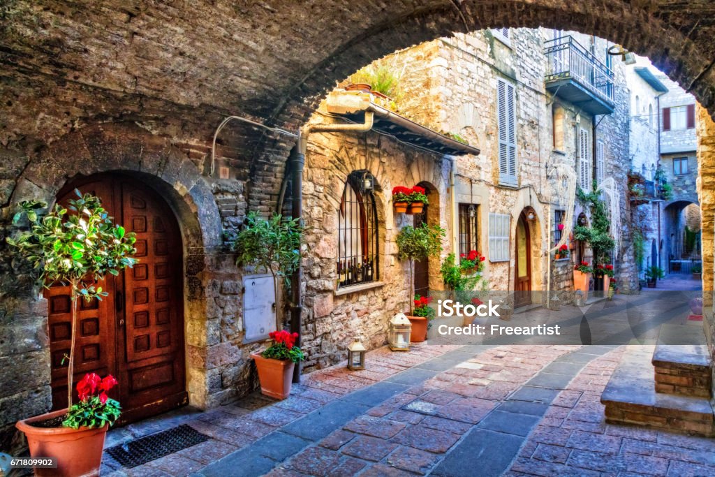 Charming old street of medieval towns of Italy, Umbria region beautiful flower decorated streets of old towns in Italy Italy Stock Photo