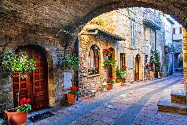 Charming old street of medieval towns of Italy, Umbria region beautiful flower decorated streets of old towns in Italy alley photos stock pictures, royalty-free photos & images