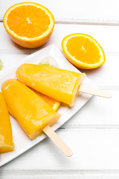 istock Homemade orange ice cream on a stick 671810064