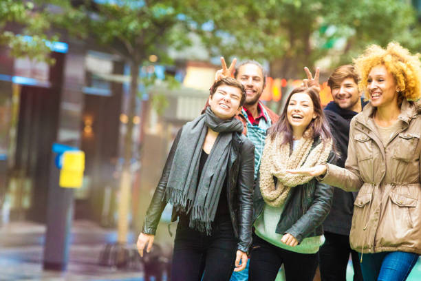 istock Five friends kidding as they walk down Manhattan street 671810624