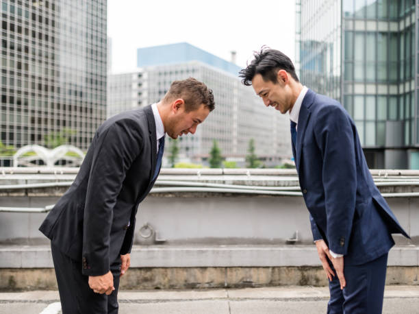 istock Japanese business persons greeting each other 671819632