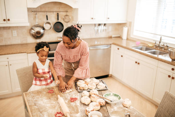 istock Mom and toddler baking together 671822156