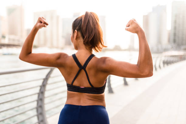 istock woman showing the muscle 671822362