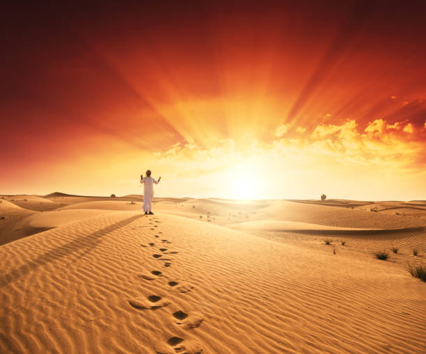 arabic man praying in the desert