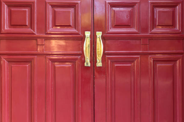 istock Old red door with brass handle, background with copy space 671823576