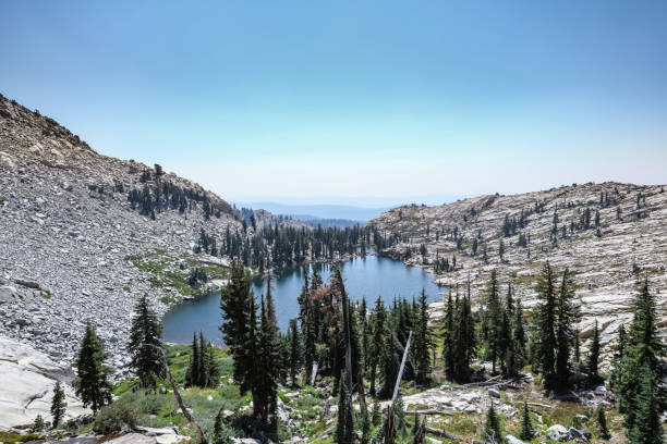 The pristine blue Lyons Lake in Desolation Wilderness, itslef found in the Sierra Nevada mountain range, is formed from annual snow melt. Granite rock scree and large boulders make up most of the terrain and result in crystal clear water.
