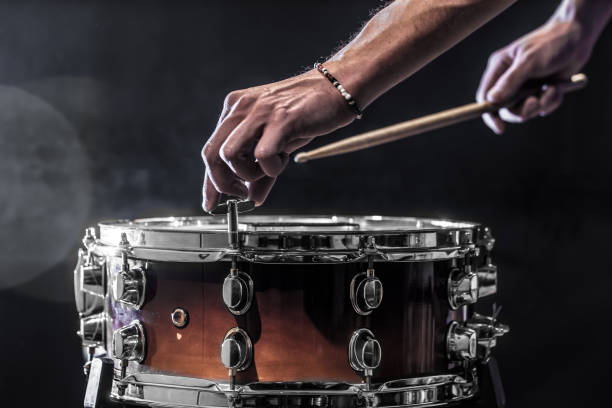 istock man adjusts a percussion instrument, musical concept with the working drum 671826064