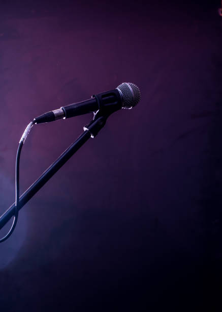 istock microphone on a black background, the music concept, beautiful lighting on the stage 671826078
