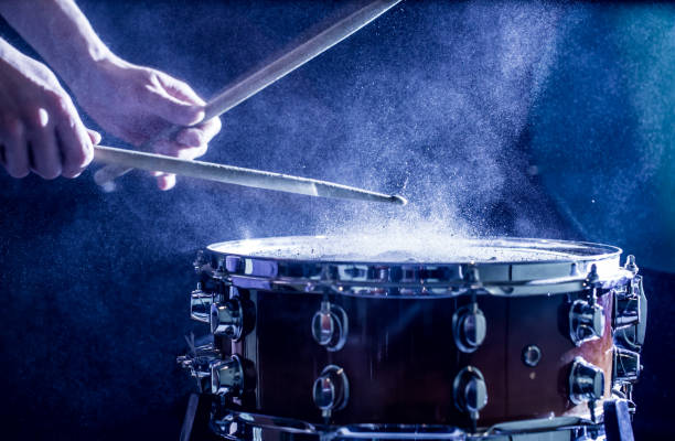 istock man plays musical percussion instrument with sticks, a musical concept, beautiful lighting on the stage 671826086