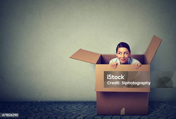 Young Woman Coming Out From A Box Stock Photo - Download Image Now - Leaving, Box - Container, People