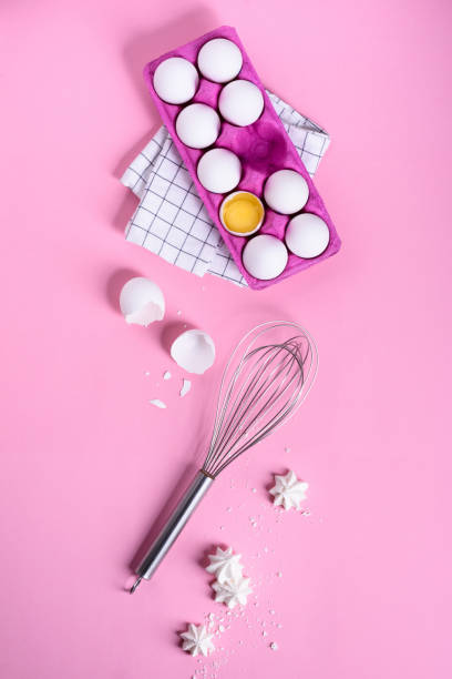 istock Egg, a cracked eggs with an egg shell, yolk and white. Cooking dessert pink background. 671832292
