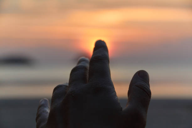 istock Hand pointing to the sun 671835870