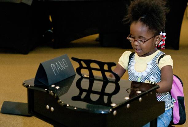 little black girl playing the piano - child prodigy imagens e fotografias de stock