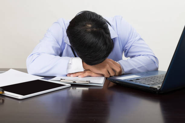 istock Tired doctor sleeping on his deck at medical office 671842888