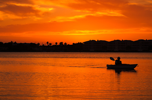 Kayaking silhouette in the sunset at the Indian River Lagoon